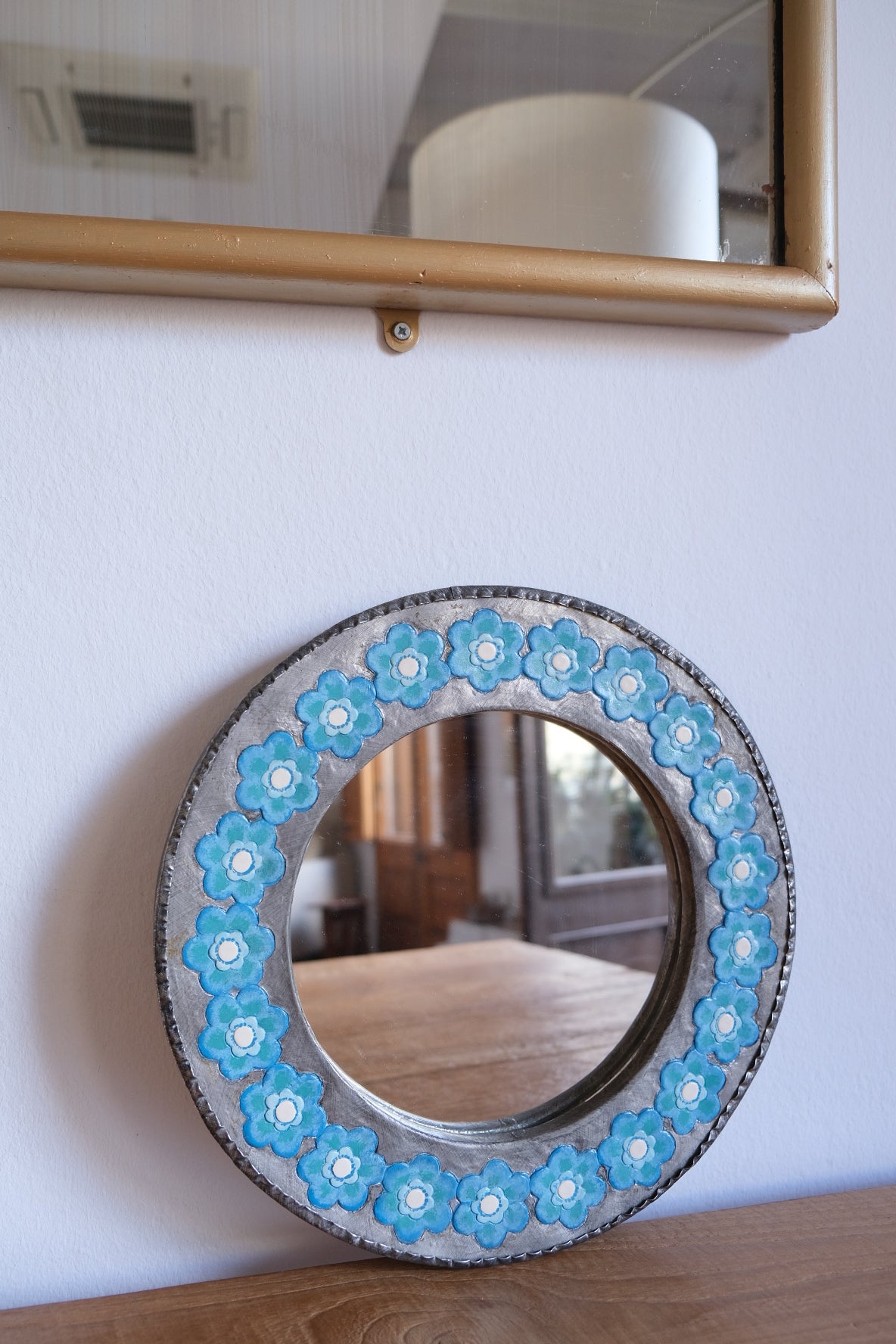 Chunky metal mirror with blue flowers