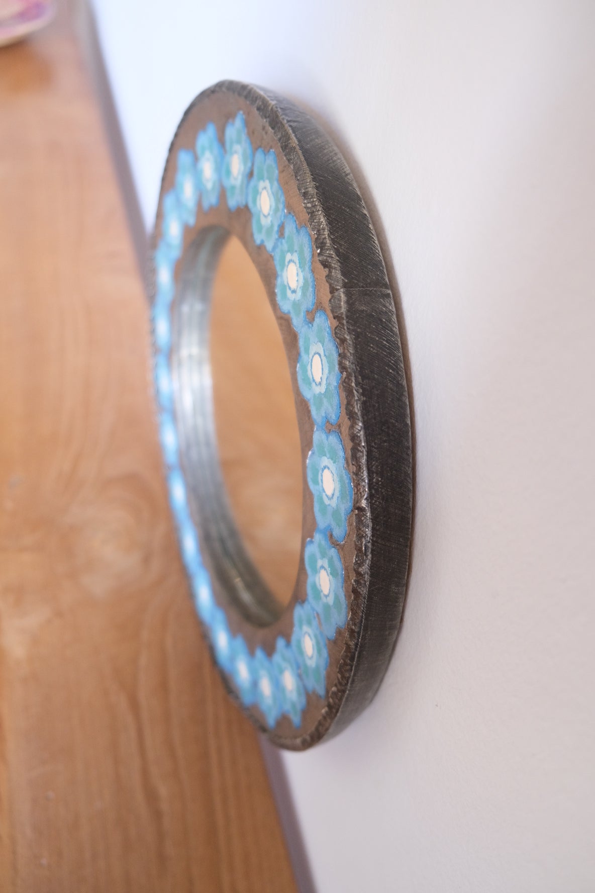 Chunky metal mirror with blue flowers