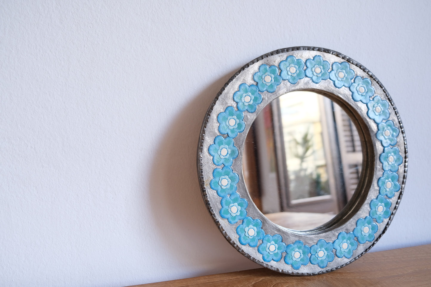 Chunky metal mirror with blue flowers