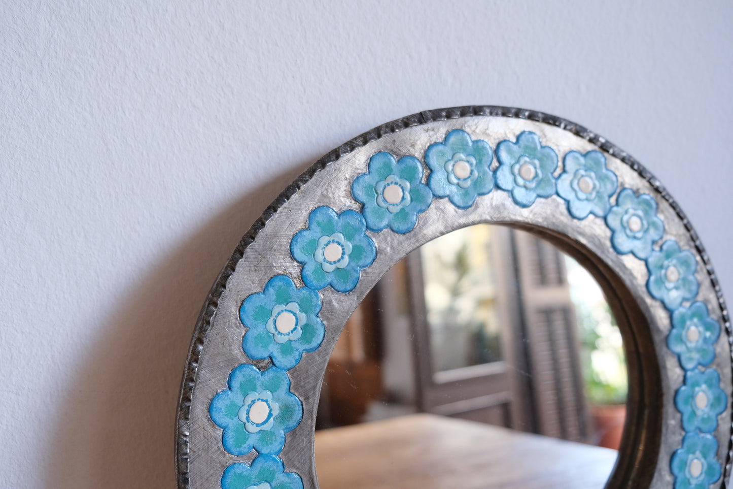 Chunky metal mirror with blue flowers