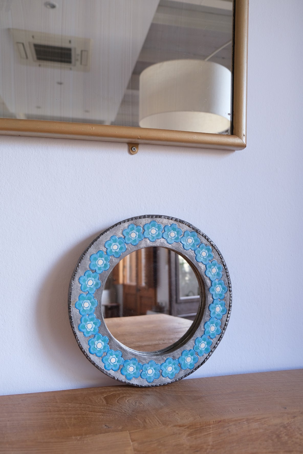 Chunky metal mirror with blue flowers