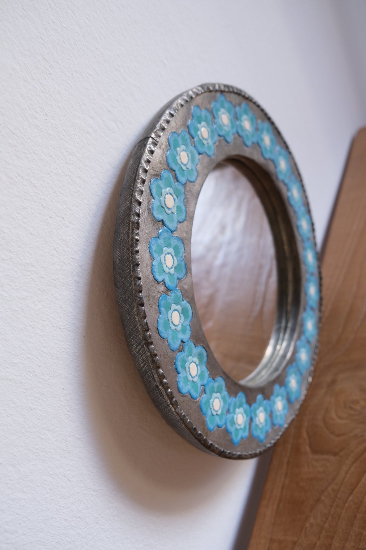 Chunky metal mirror with blue flowers