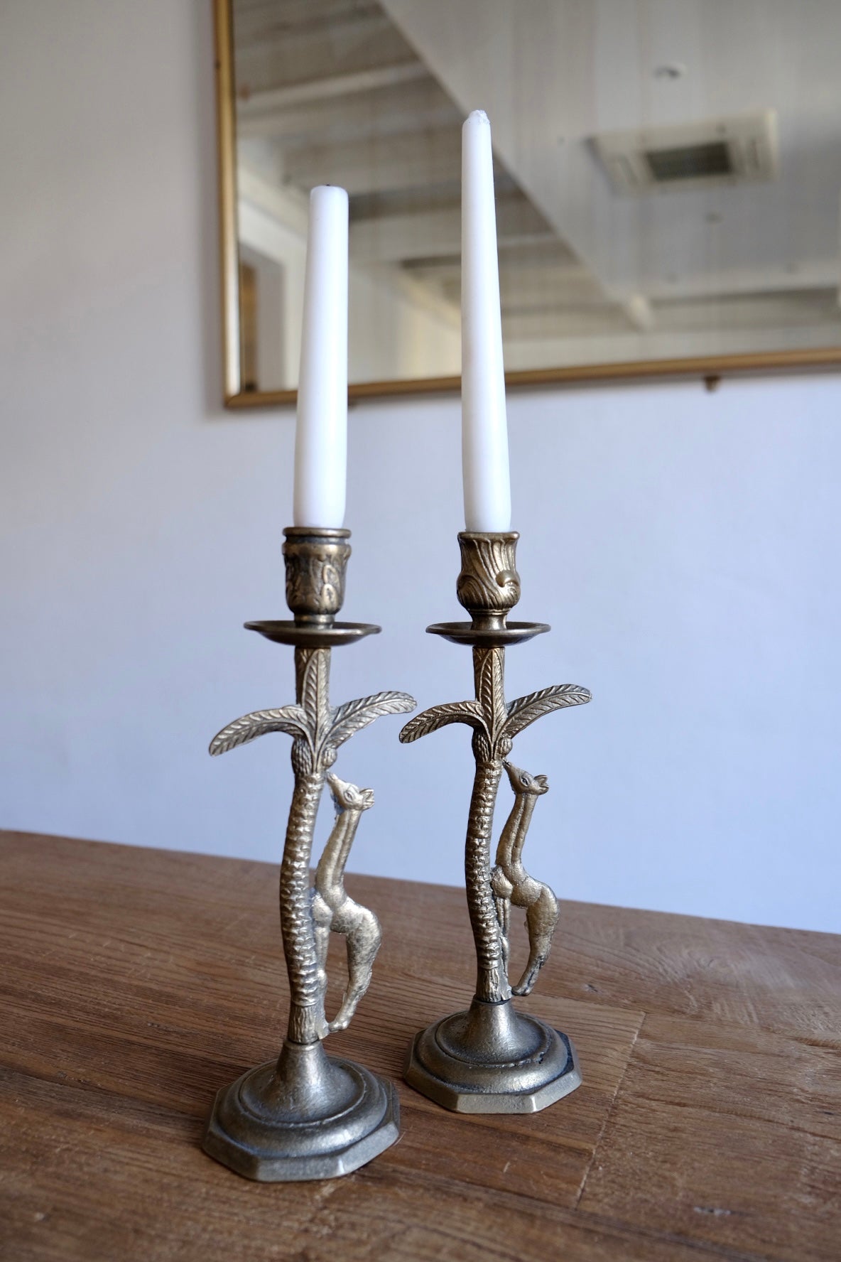 Pair of ornate brass giraffe figurine candlestick holders