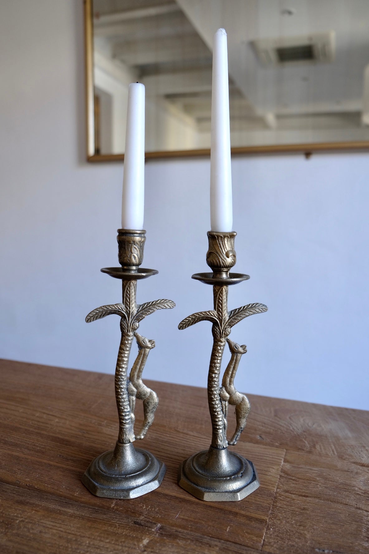 Pair of ornate brass giraffe figurine candlestick holders