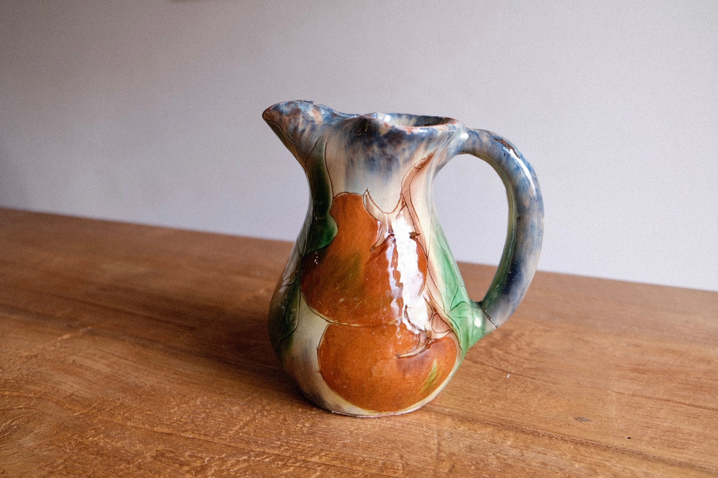 Ceramic jug with lemons and tomatoes