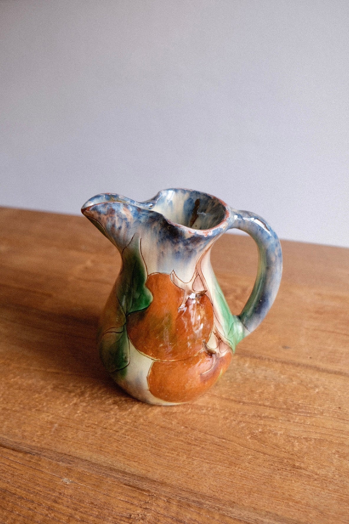 Ceramic jug with lemons and tomatoes