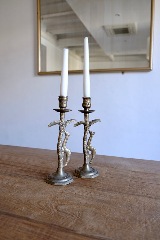 Pair of ornate brass giraffe figurine candlestick holders