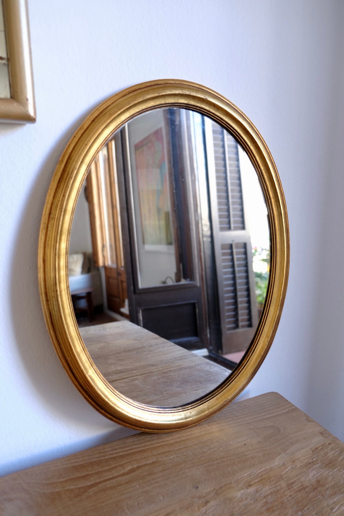 Vintage facet cut oval giltwood mirror